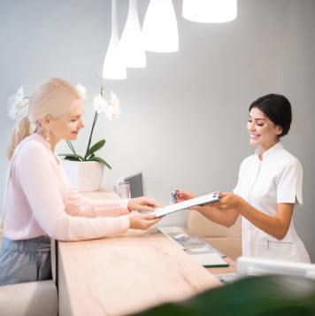 Working at the front desk taking patient's information